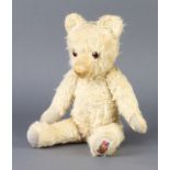 An Alpha yellow teddy bear with articulated limbs 33cm Wear to pads