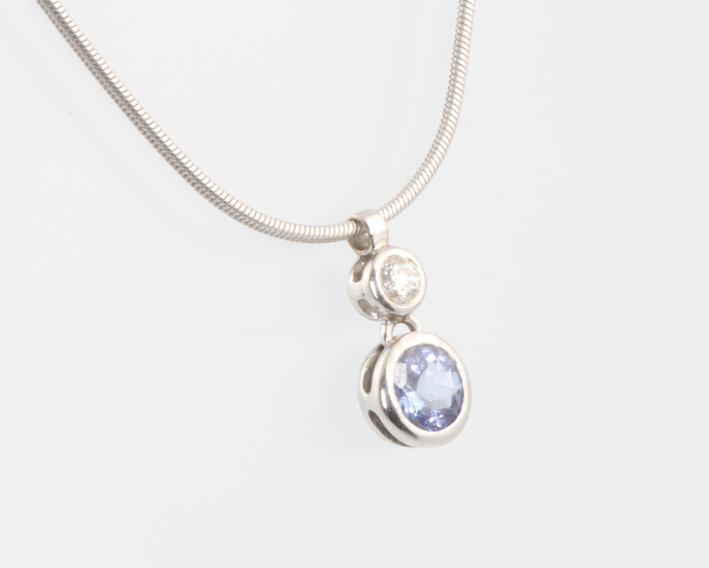 An 18ct white gold necklace with brilliant cut tanzanite and diamond pendant, the tanzanite 0.