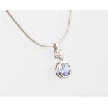 An 18ct white gold necklace with brilliant cut tanzanite and diamond pendant, the tanzanite 0.