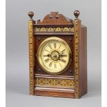 An American striking alarm clock with paper dial, Roman numerals contained in a walnut and gilt