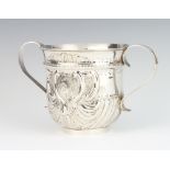 A George III silver repousse porringer with demi fluted decoration and chased armorial, London 1760,