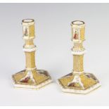 A pair of 19th Century German hexagonal candlesticks decorated with panels of figures 14cm Both have