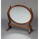 A Georgian style oval plate dressing table mirror contained in a mahogany swing frame 43cm h x