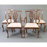 A set of 4 1930's Chippendale style carved walnut dining chairs with pierced vase shaped slat backs,