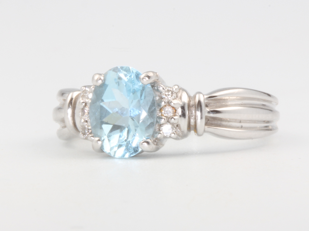 An 18ct white gold oval aquamarine and diamond ring the centre stone approx. 1.1ct, diamonds 0.06ct,