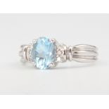 An 18ct white gold oval aquamarine and diamond ring the centre stone approx. 1.1ct, diamonds 0.06ct,