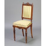 A Victorian walnut nursing chair with carved cresting rail and finials, upholstered seat and back,