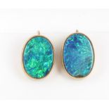 A pair of yellow gold and black opal oval earrings 15mm x 10cmm One opal has a small chip to the
