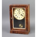 An American mantel timepiece with paper dial and Roman numerals complete with pendulum and key