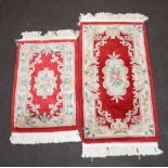 A white floral patterned Chinese rug 128cm x 70cm and 1 other 94cm x 96cm (both with some staining)