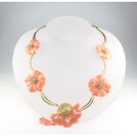 An Italian 18ct yellow gold and coral necklace, carved with 5 flower heads, set with emeralds