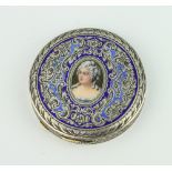 An 800 standard enamelled circular compact decorated with a portrait of a lady 70 grams gross, 6cm