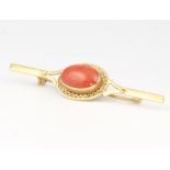 An 18ct yellow gold etruscan style cabochon cut oval coral brooch, 4.2 grams, 58mm