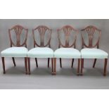 A set of 4 mahogany Hepplewhite style shield back dining chairs with over stuffed seats, raised on