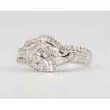 An 18ct white gold baguette and diamond crossover ring approx. 0.43ct, size M