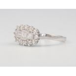 An 18ct white gold baguette and brilliant cut diamond cluster ring size M 1/2, 0.5ct