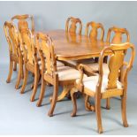 A Queen Anne style figured walnut dining suite comprising twin pillar extending dining table with