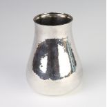 A silver bulbous hammer pattern vase, London 1984, 339 grams, 13cm Several scratches to this lot