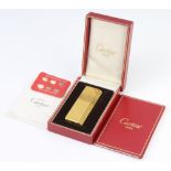 A gentleman's gold plated cased Cartier cigarette lighter The box is broken