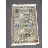 A white and blue silk Persian rug formed of 24 floral square panels 123cm x 76cm