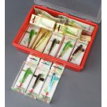 A plastic lure box containing a collection of 12 Allcocks Devon minnow fishing lures and an Allcocks