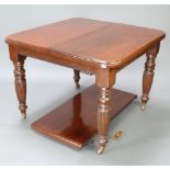 A Victorian mahogany extending dining table with 1 extra leaf, raised on turned and reeded