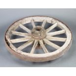 A wooden and iron 12 spoked cart wheel 85cm diam. Signs of old but treated worm in places