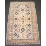A pink, cream, green and floral patterned Caucasian style rug within a 3 row border 233cm x 140cm