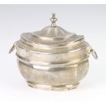 A Georgian silver Adam style tea caddy with urn finial and lion ring handles Glasgow marks rubbed,
