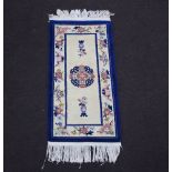 A blue and white ground Chinese rug 128cm x 62cm There is a slight stain to the centre and fringe