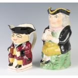 A 19th Century Staffordshire Toby jug 23cm and a later ditto 17cm The 2nd item is stuck