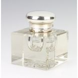 A silver topped square clear glass inkwell with bright cut base, London 1931, 12cm The base is