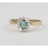 A 9ct yellow gold oval emerald and diamond cluster ring 1.7 grams, size L