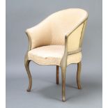 An Edwardian bleached mahogany show frame tub back chair upholstered in cream material on cabriole