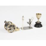 A miniature silver figure of a lamp lighter, a cannon and a cup 56 grams