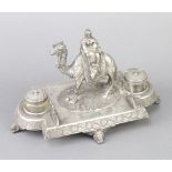 A Victorian ex-plated ink stand with a figure riding a camel and having 2 lidded inkwells and a