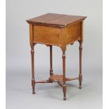 An Edwardian rectangular square sewing box with hinged lid, raised on turned supports with