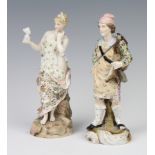 A 19th Century German porcelain figure of a lady holding a portrait bust of a classical lady