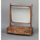 A 19th Century rectangular bevelled plate dressing table mirror raised on a mahogany bow front