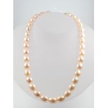 A string of cultured pearls with an 18ct yellow gold clasp 42cm