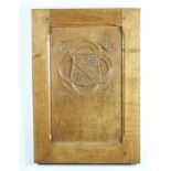 A rectangular carved oak panel with armorial decoration 64cm x 45cm x 3cm