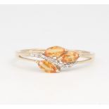 A 9ct yellow gold fire opal and diamond crossover ring, 2.2 grams, size U
