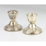 A pair of turned silver dwarf candlesticks 1993, 6cm
