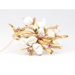A 14ct yellow gold baroque pearl and ruby open scroll brooch 16.8 grams, 55mm x 35mm