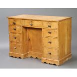 A Victorian pine pedestal dressing table/desk fitted a drawer above a cupboard enclosed by a