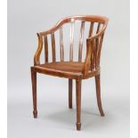 An Edwardian inlaid mahogany tub back chair raised on square tapered supports, spade feet Some