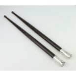 A pair of silver mounted hardwood drum sticks, 41cm Both mounts are dented