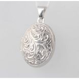 A 9ct white gold engraved oval locket 2.6 grams gross, 25mm