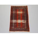 A brown and white ground Bokhara rug with 10 octagons to the centre with a multi row border 122cm