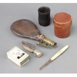A 19th Century leather and brass shot flask, a Winston Churchill match slip, folding pocket knife